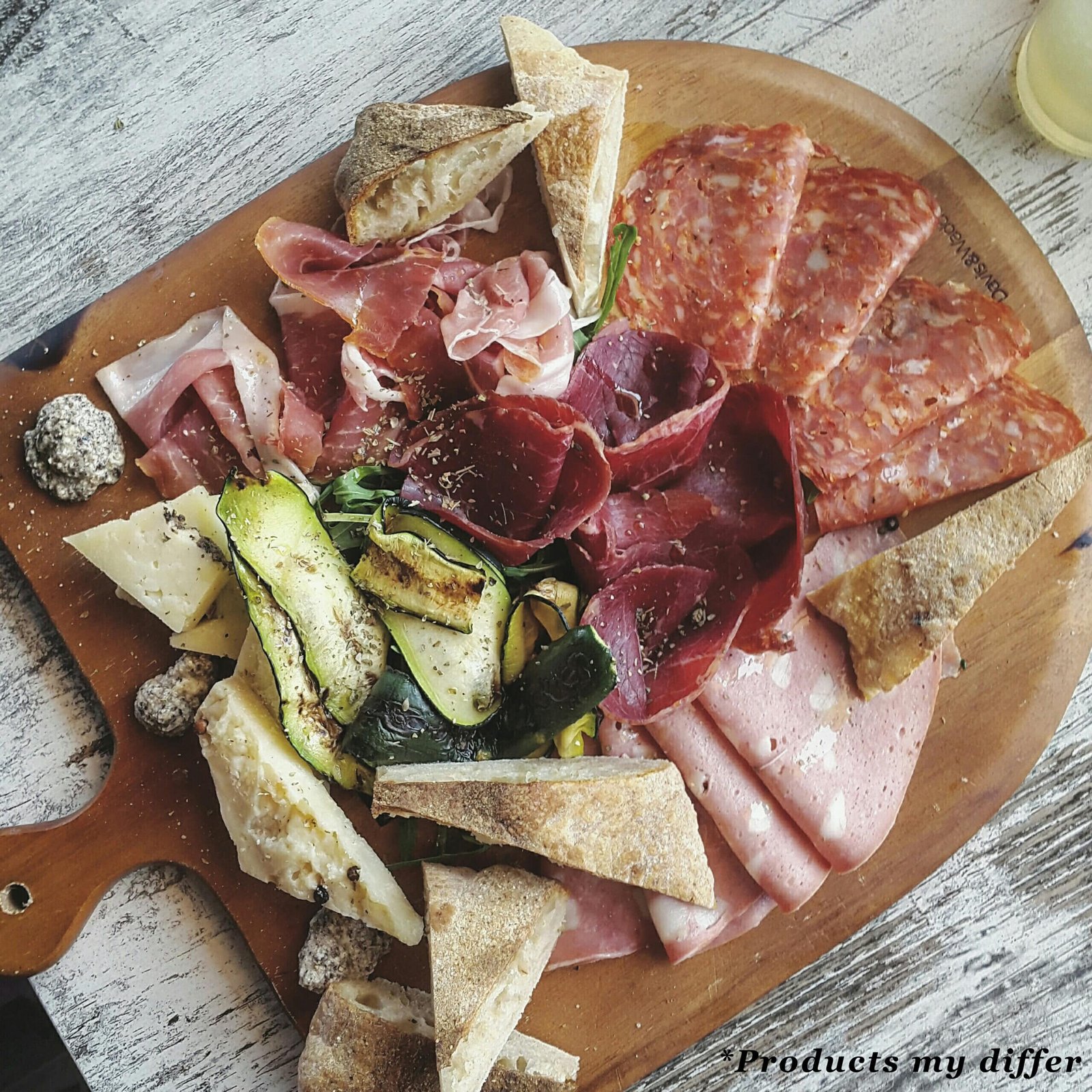 Appetizer board with cheese, nuts, fruits, toasts and charcuteri
